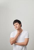 Man has a terrible pain in throat because of flu. He lost his voice and can not speak photo
