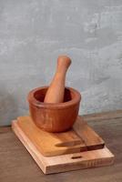 Kitchen tools for cooking on a wooden table on the background of a concrete wall. Copy space photo