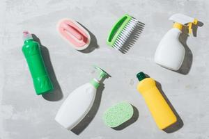 House cleaning products on wooden table. Salt pelets, baking soda sodium bicarbonate, detergent, spray photo