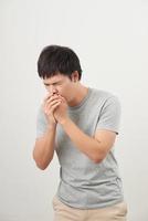 Mature man coughing on white background photo