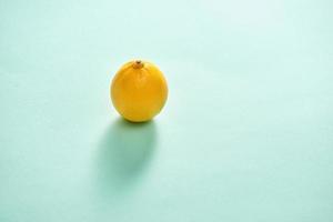 Ripe lemon fruit isolated on blue background photo