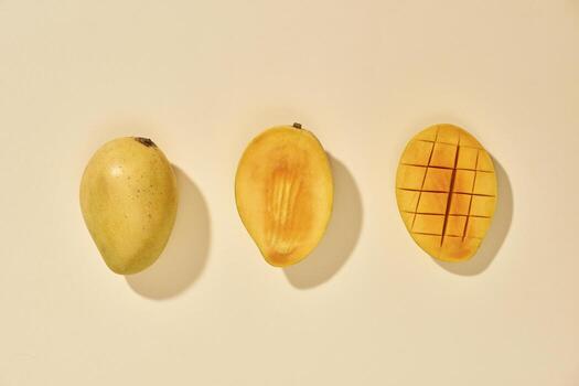 Fresh and beautiful mango fruit with sliced diced mango chunks on pastel background, copy space text space, blank for text, top view. photo