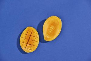 mango on a dark wood background. tinting. selective focus on the mangos slices photo