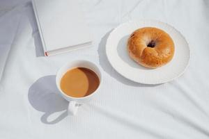 coffee, a good book and bread for a good morning in cafeteria photo