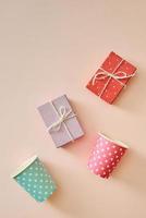 Cups and gift boxes wrapped in polka dots colorful paper photo