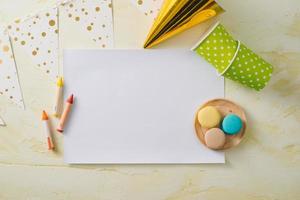 Party management and organization concept with sweets, confetti and blank pages. Creative celebration flat lay with copy space. photo