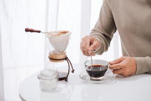 Young man enjoying coffee and breakfast at a cafe photo