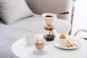 Serving hot coffee in the living room of his home in the morning photo