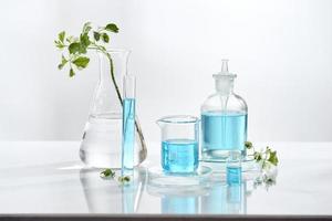 laboratory glass equipment with natural ingredients on white background photo