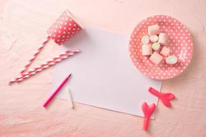 Party management and organization concept with sweets, confetti and blank pages. Creative celebration flat lay with copy space. photo