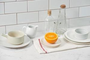 Orange in a dish on the table in the kitchen photo