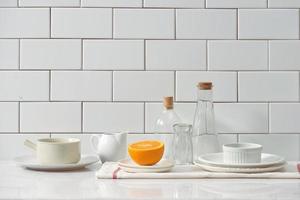 Orange in a dish on the table in the kitchen photo