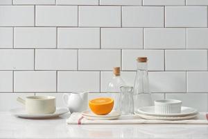 Orange in a dish on the table in the kitchen photo