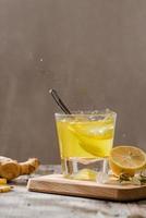 refreshing citrus lemonade,summer drink. Lemonade with fresh lemon on wooden background photo