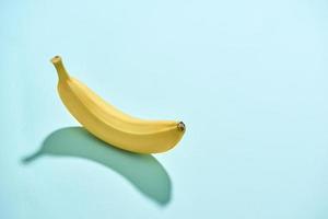 Ripe banana isolated on blue background photo