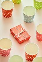 Cups and gift boxes wrapped in polka dots colorful paper photo