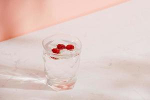 A glass of fresh soda with raspberries photo
