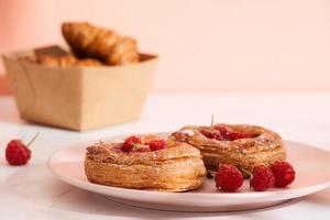 Homemade puff pastry with raspberries. Sweet tasty dessert. decorated with powdered sugar photo