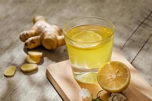 refreshing citrus lemonade,summer drink. Lemonade with fresh lemon on wooden background photo