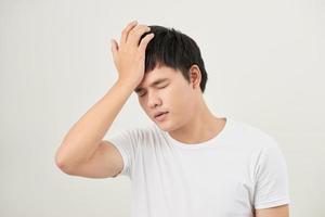 asian man suffering from headache, vertigo, hangover, migraine, stress photo