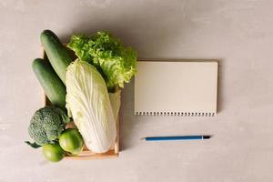 Fresh vegetables in wooden tray. Healthy food ingredients. Organic farmer vegetables. Top view. photo