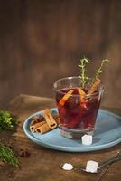 Cold ginger tea with orange and lemon in glass cups. Tea with sugar. The decor. Cinnamon and Rosemary Spices photo