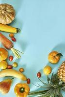 Collection of fresh yellow fruit and vegetables on the light blue background photo