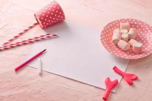 Party management and organization concept with sweets, confetti and blank pages. Creative celebration flat lay with copy space. photo