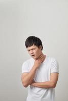Man has a terrible pain in throat because of flu. He lost his voice and can not speak photo
