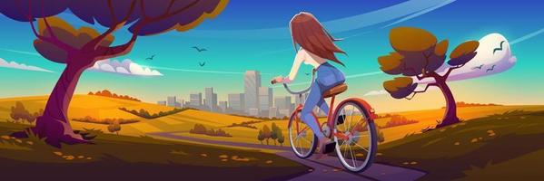 niña monta en bicicleta en el camino a la ciudad en otoño vector