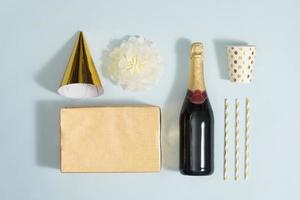 Flat lay Christmas or party background with gift boxs, champagne bottle, bows, decorations and wrapping paper in gold . Flat lay, top view photo