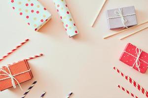 Colorful gifts over pink background, flat lay style with copy space photo