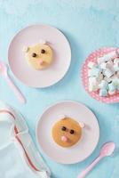 Funny pancake in a shape of teddy bear, food for kids idea, top view photo