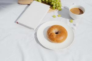 coffee, a good book and bread for a good morning in cafeteria photo