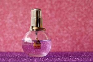 TERNOPIL, UKRAINE - SEPTEMBER 2, 2022 Lanvin Eclat Darpege perfume bottle on shiny glitter background in purple colors photo