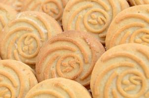 Close-up of a large number of round cookies with coconut filling photo