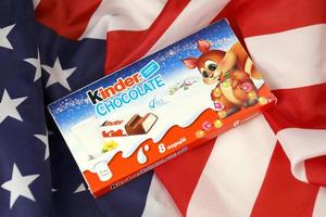 KHARKIV, UKRAINE - DECEMBER 16, 2021 Kinder Chocolate is a children dessert snack made by Italian confectionery brand Ferrero S.p.A. photo