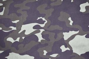 Texture of fabric with a camouflage painted in colors of the marsh. Army background image photo