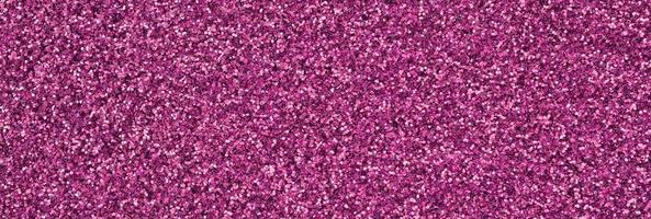 Pink decorative sequins. Background image with shiny bokeh lights from small elements photo