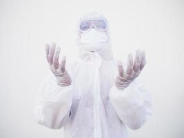 Closeup of asian male doctor or scientist in PPE suite uniform has stress and pray during an outbreak of coronavirus or COVID-19 isolated white background. photo