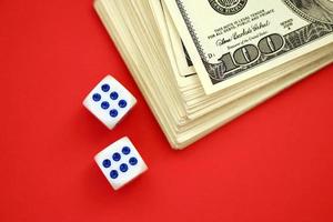 Money, finance and gambling concept. Close up on an American hundred US dollar banknotes and two white dice on top showing the numbers six photo