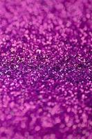 Pink decorative sequins. Background image with shiny bokeh lights from small elements photo