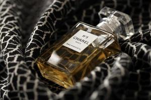 TERNOPIL, UKRAINE - SEPTEMBER 2, 2022 Chanel Number 5 Eau Premiere worldwide famous french perfume bottle on monochrome plaid photo