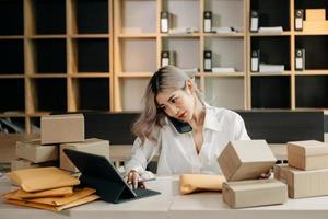 Small business entrepreneur SME freelance woman working at home office, BOX,tablet and laptop online, marketing, packaging, delivery,  e commerce concept