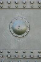 The texture of the wall of the tank, made of metal and reinforced with a multitude of bolts and rivets. Images of the covering of a combat vehicle from the Second World War photo