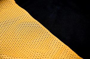 Close up of orange polyester nylon sportswear shorts to created a textured background photo