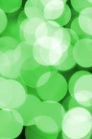 Green abstract Christmas blurred luminous background. Defocused artistic bokeh lights image photo