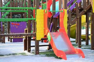 Fragment of a playground made of plastic and wood, painted in different colors photo