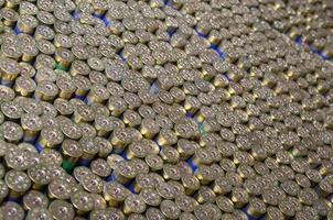 Pattern of 12 gauge cartridges for shotgun bullets. Shells for hunting rifle close up. Backdrop for shooting range or ammunition trade concepts photo