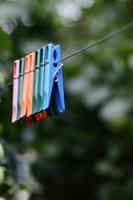 Clothespins on a rope hanging outside house and apple tree photo